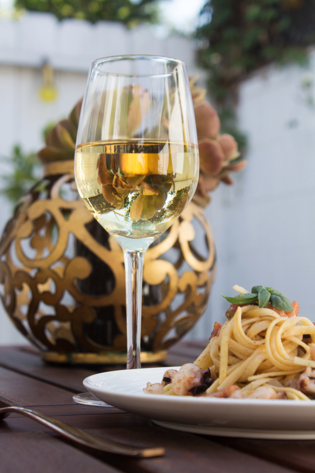 A nice glass of chardonnay and seafood pasta