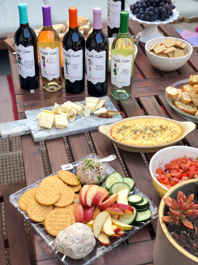 Middle Sister wines on the table with a delicious spread