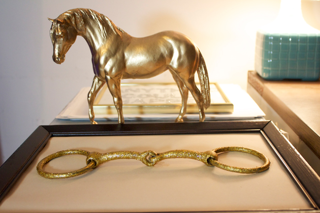 glittery gold horse bit and statue