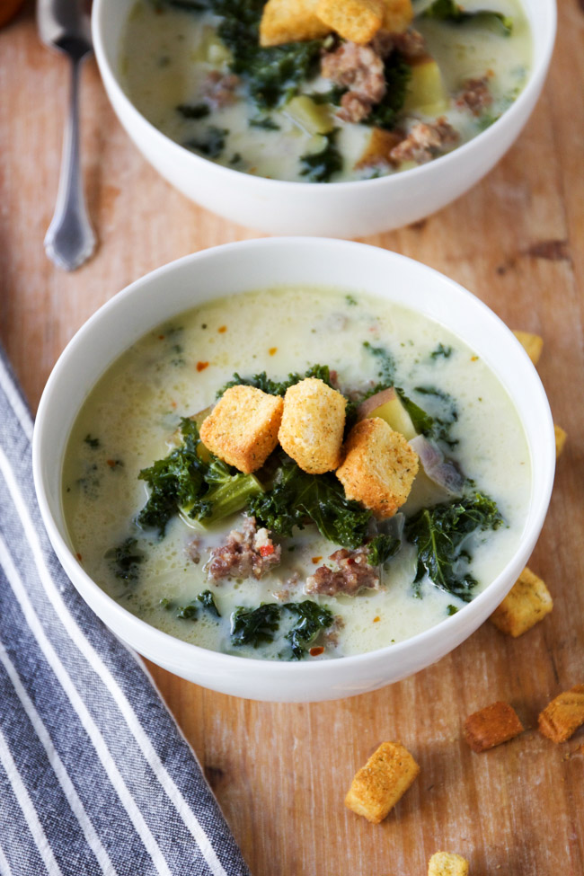 Easy and delicious spicy sausage and kale soup topped with croutons