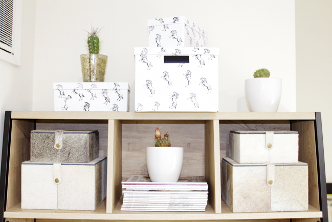 Neutral and organized office space with horse print and cowhide boxes