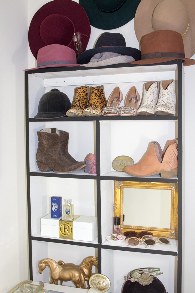Organized shelf of shoes, hats, perfume, and accessories