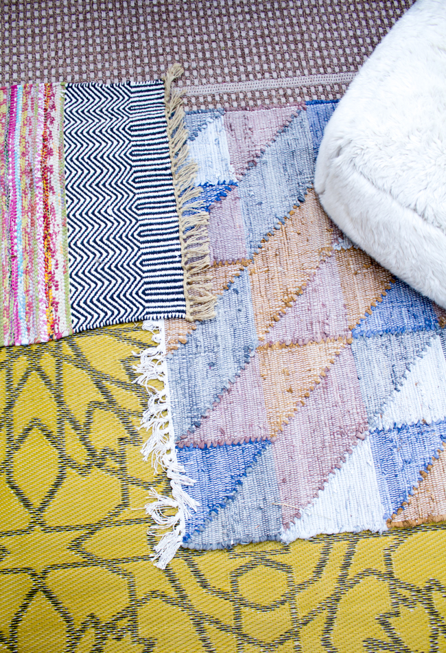 layered outdoor rugs create a bohemian vibe in this small patio