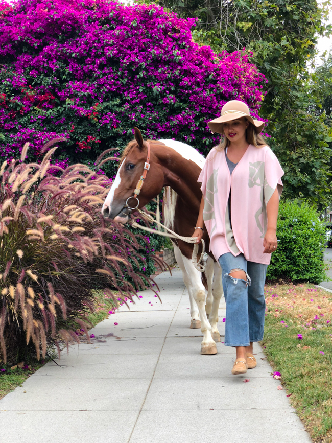 Equestrian style in the summer. Pink poncho and floppy hat